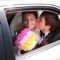 Closeup of newlywed couple kissing in wedding car