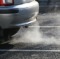 Car exhaust fumes coming from automobile polluting city air