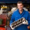 Mechanic holding car part