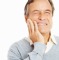 Closeup of a senior man holding teeth in pain