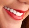 Close-up of a beautiful woman toothy smile with red lips